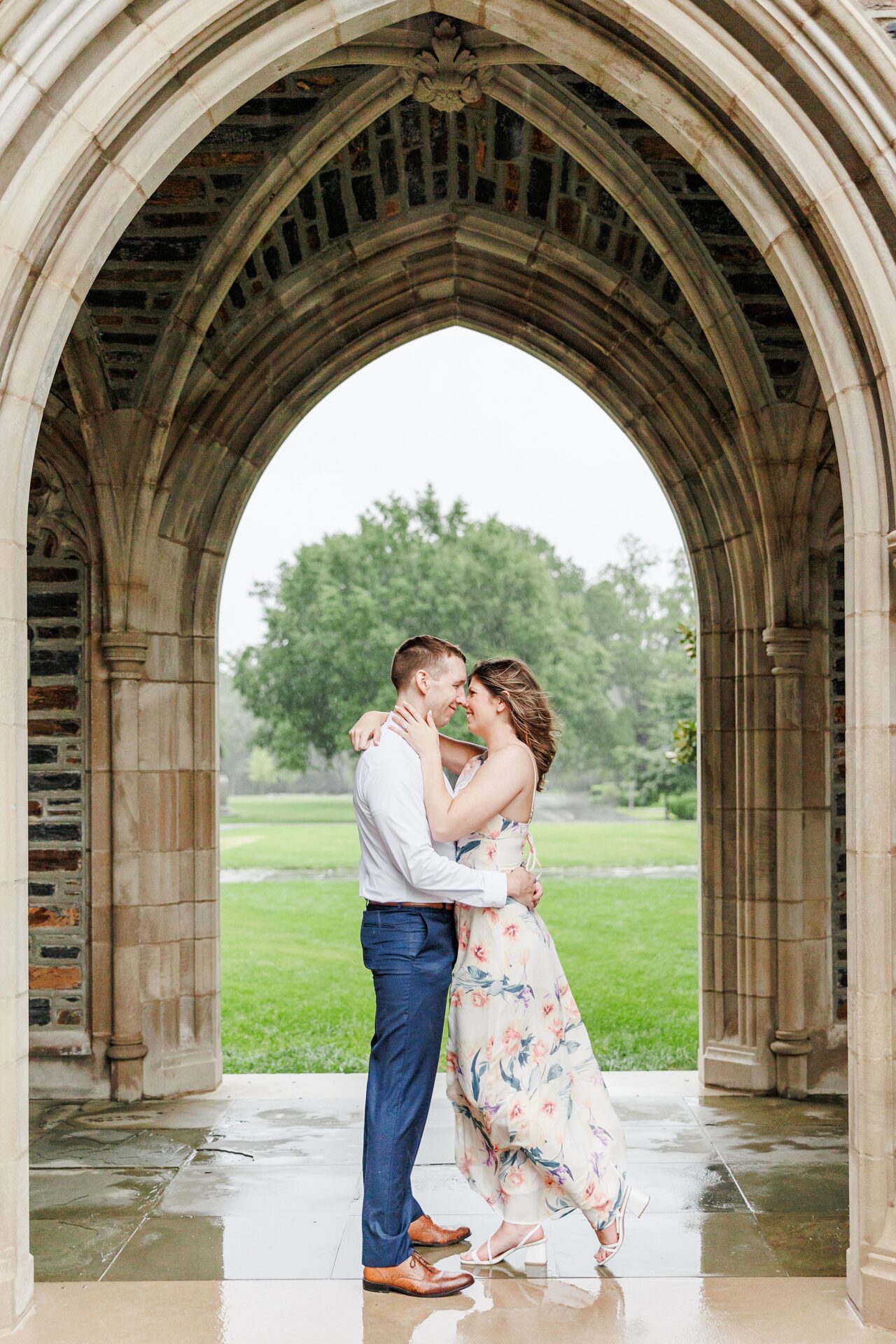 Durham engagement session featuring Duke Chapel archways and romantic rainy weather