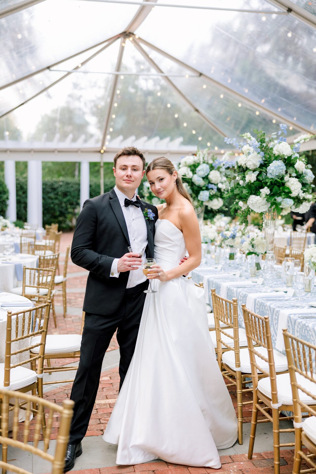 Duke Mansion tented summer wedding reception with classic white and blue florals